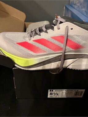 adidas running shoe in gray with neon pink and neon yellow accents